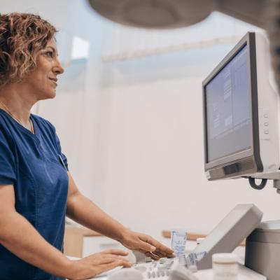 A healthcare worker looking at a computer display