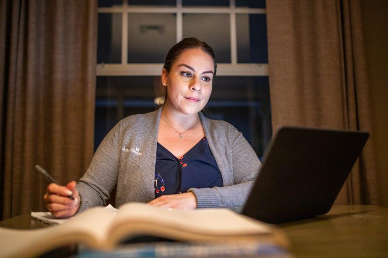 Nurse studying on a laptop