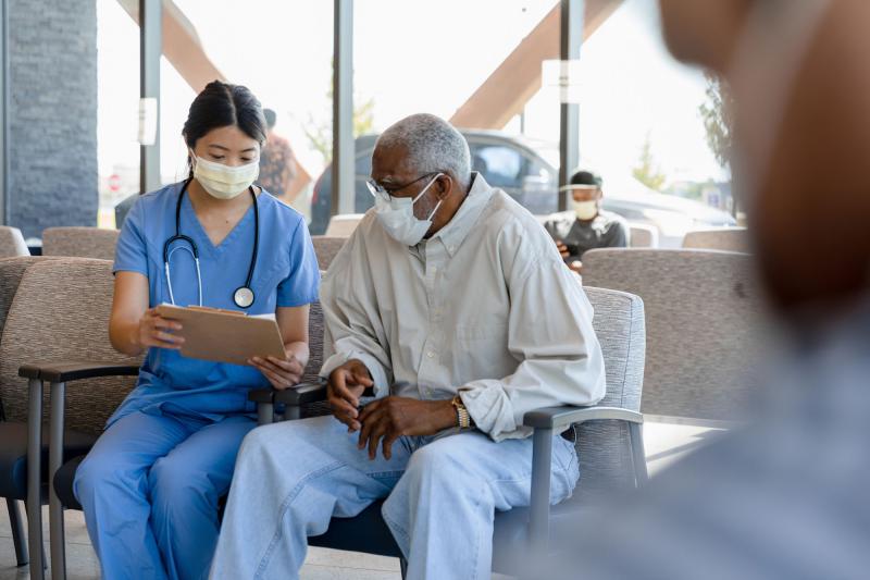 A triage nurse conversing with a patient