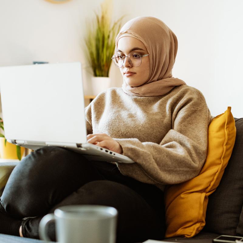 Woman on couch with laptop