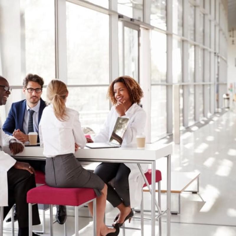 healthcare-administrators-sit-around-a-table