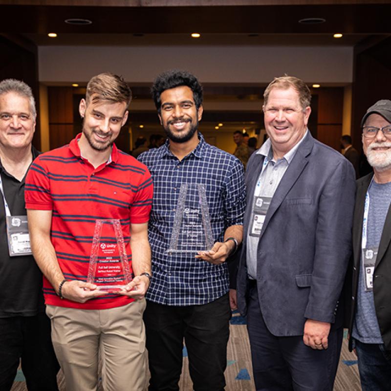 AHU and Fullsail team members poser with awards